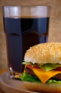 Cheeseburger and cola Stock Photos