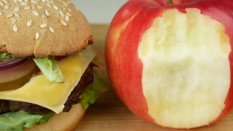 Cheeseburger and red apple Stock Footage 241807895