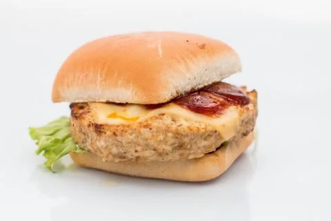Cheeseburger with beef cutlet, bacon, tomatoes and cheese slices, seasoned wi Foto stock