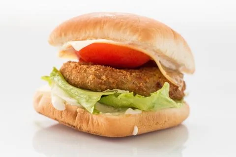 Cheeseburger with beef cutlet, bacon, tomatoes and cheese slices, seasoned wi Stock Photos