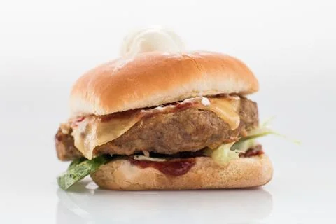 Cheeseburger with beef cutlet, bacon, tomatoes and cheese slices, seasoned wi Foto stock