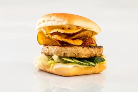 Cheeseburger with beef cutlet, bacon, tomatoes and cheese slices, seasoned wi Foto stock