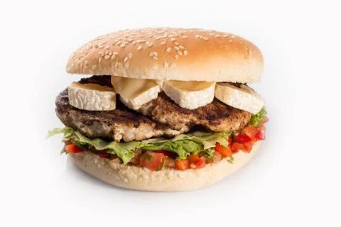 Cheeseburger with beef cutlet, bacon, tomatoes and cheese slices, seasoned wi Stock Photos