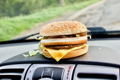 Cheeseburger in car Stock Photos
