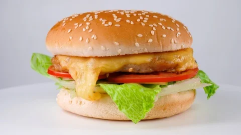 Cheeseburger with chicken and fresh vegetables, served in restaurant Stock Footage 87790976