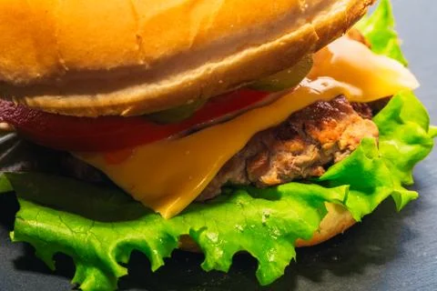 Cheeseburger closeup on a gray background Stock Photos