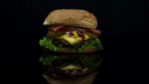 Cheeseburger Comes Into Focus on a glossy table Stock Footage 243615661