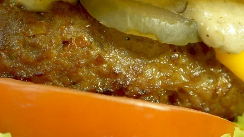 Cheeseburger with eggplant sauce, beef, cheddar cheese, lettuce, tomato. Stock Footage 94457532