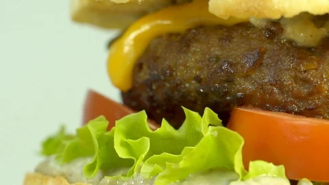 Cheeseburger with eggplant sauce, beef, cheddar cheese, lettuce, tomato. Video stock 94457544