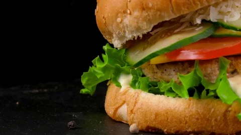 Cheeseburger with fresh vegetables and sauce, served with Fried Potato wedges Stock Footage 84652118