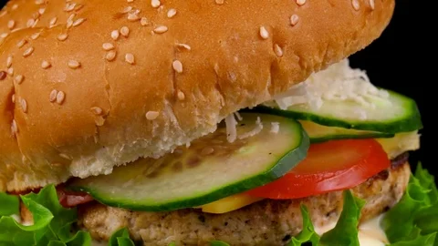 Cheeseburger with fresh vegetables and sauce, close-up view Stock Footage 84653202