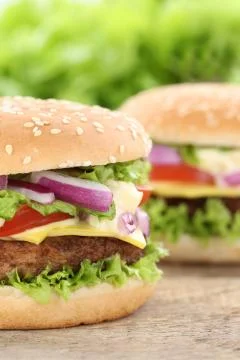 Cheeseburger hamburger closeup close up beef tomatoes lettuce cheese Stock Photos