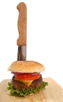 Cheeseburger with knife in it Stock Photos