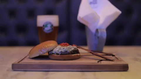 Cheeseburger made with Gorgonzola Cheese, Red Pepper, Honey Souce and Bacon Stock Footage 129032053