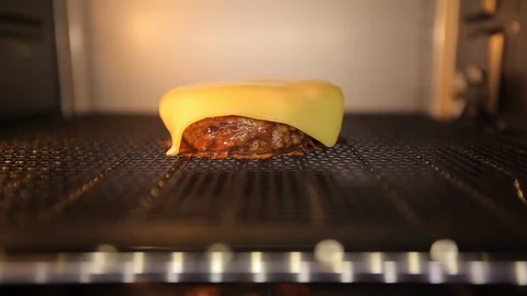 Cheeseburger. Melting cheese on broiled burger. timelapse Stock Footage