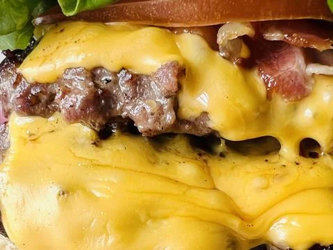 Cheeseburger with oozing melted cheese Stock Photos