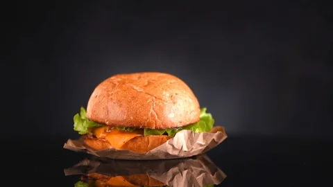 Cheeseburger rotated on black background. Fresh Hamburger on fresh buns Stock-Footage 101460390