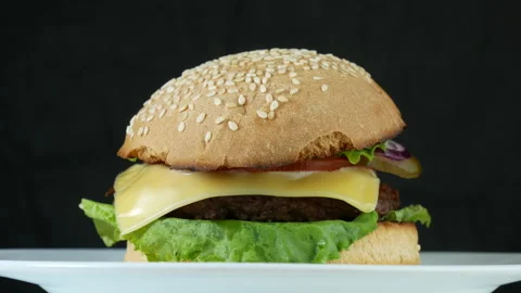 Cheeseburger on a white plate Stock Footage 241812139