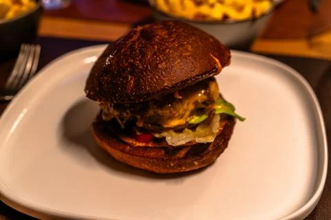 Cheeseburger on white plate in restaurant Stock Photos