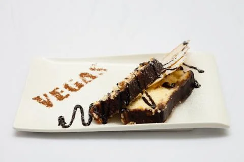 Cheesecake with apple on a white background, chocolate watering. Stock Photos