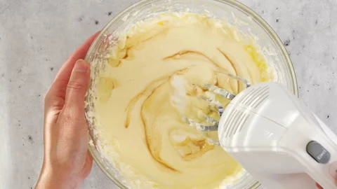 Cheesecake batter for the mini cheesecake recipe. Mixing ingredients Stock Footage 278954716