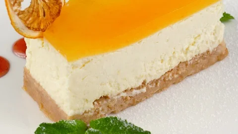 Cheesecake with caramelized orange, mint leaf, close-up view Stock Footage 90660555