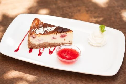 Cheesecake with chantilly cream and coulis Stock Photos