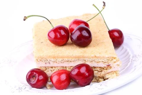Cheesecake with a cherry on a white background sweet dessert Stock Photos