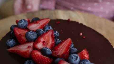 Cheesecake with chocolate icing and strawberries and blueberries Stock Footage 142492424