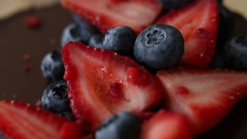 Cheesecake with chocolate icing and strawberries and blueberries Stock Footage 142492463