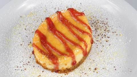 Cheesecake decorated with strawberry jam, served in Restaurant Stock Footage 95464780