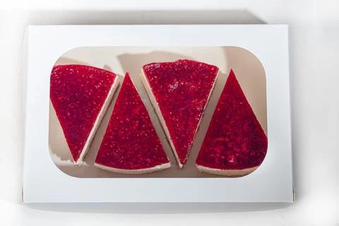 Cheesecake on a light background. Top with raspberry jelly. Home delivery. Fe Фото