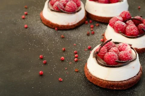 Cheesecake with raspberry on dark border background. Free space for your text. Stock Photos