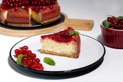 Cheesecake with red currant and mint on wooden board. Top view. Stock Photos