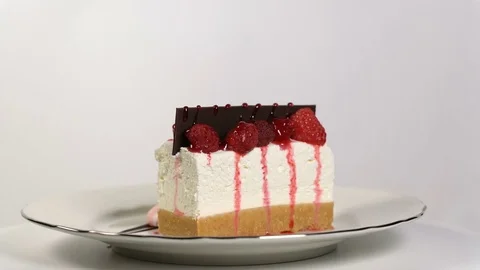 Cheesecake rotates on the turntable on a white background Stock Footage 84834904