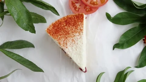 Cheesecake with tomatoes. white pie surrounded by green leaves Video stock 147443956
