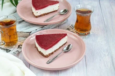 Cheesecake on two white plates, two servings. On a white background decorated Фото
