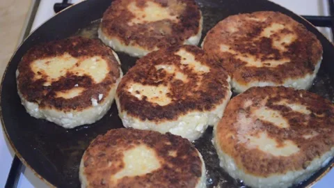 Cheesecakes are fried in a pan Stock Footage 132215236
