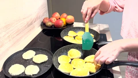 Cheesecakes are overcooked in a frying pan Stock Footage 280171781