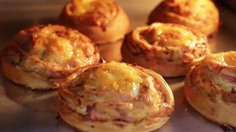 Cheesecakes with ham and cheese in a large oven Stock Footage 146574216