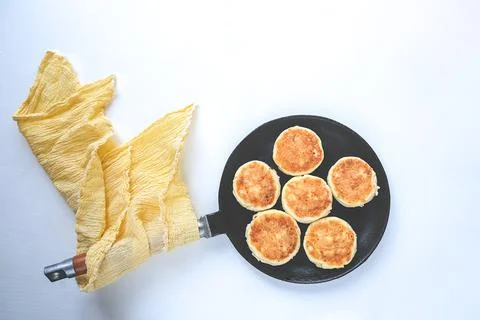 Cheesecakes in a pan, on a white background. Stock Photos