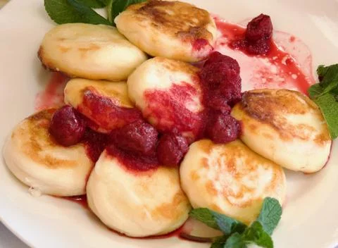 Cheesecakes with raspberry jam for breakfast Stock Photos