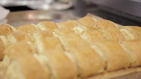 Cheesecakes stand on table on baking sheet with golden crust, inside. Stock Footage 78731228