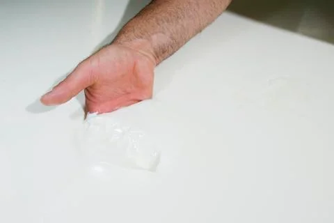 Cheesemaker controls the milk curd Stock Photos