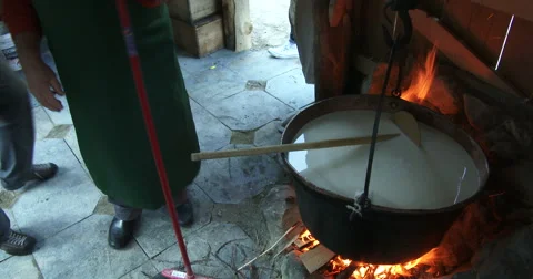 Cheesemaking of Mountain Cheese in a log cabin. Stock-Footage 69007187
