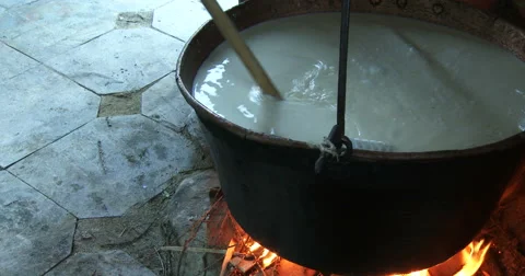 Cheesemaking of Mountain Cheese in a log cabin.  Stock Footage 69009414