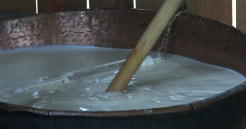 Cheesemaking of Mountain Cheese in a log cabin.  Stock Footage 69014094