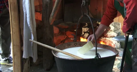 Cheesemaking of Mountain Cheese in a log cabin. Stock Footage 69042345