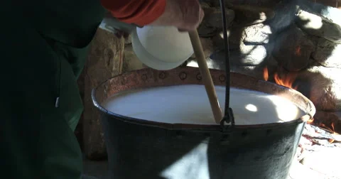 Cheesemaking of Mountain Cheese in a log cabin. Video stock 69049149