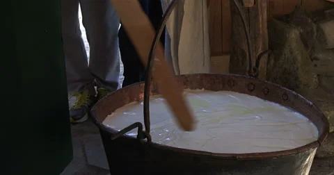 Cheesemaking of Mountain Cheese in a log cabin.  Stock Footage 69070468